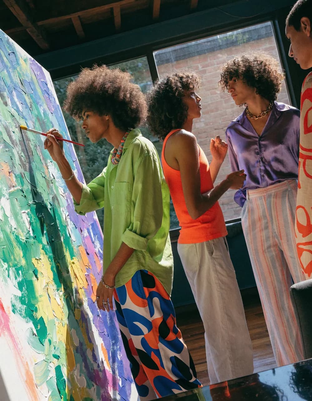 An artist painting a vivid canvas at a gathering.