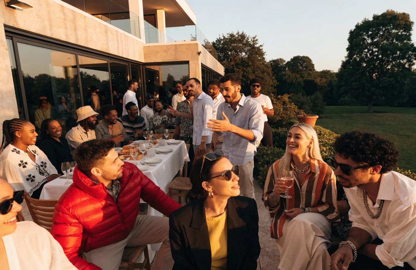 A lively villa-terrace dinner at golden hour.